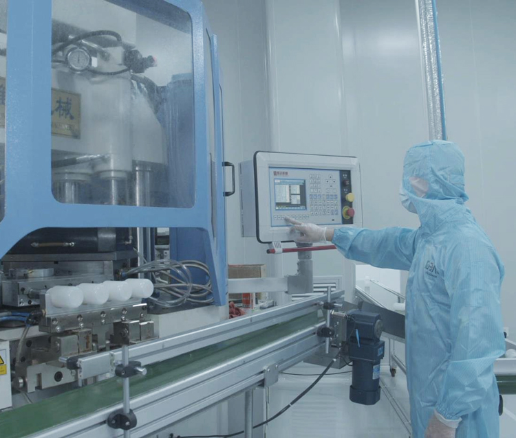 IDEAL cleanroom operator working with production equipment